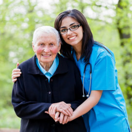 caregiver and old woman showing their genuine smile
