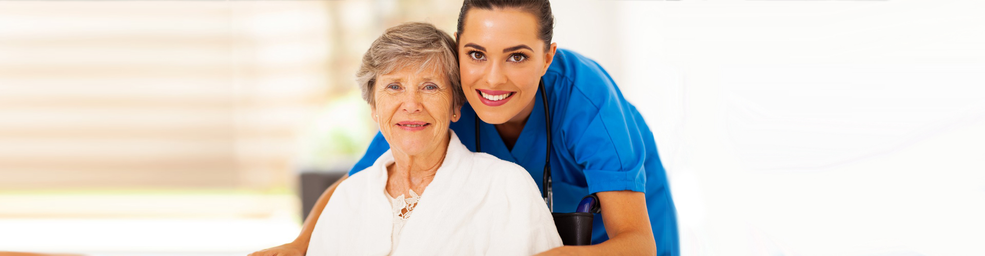 a nurse and a senior woman smiling
